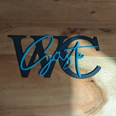 Biểu trưng nhà vệ sinh Gäste/Guests bằng chữ viết nghệ thuật