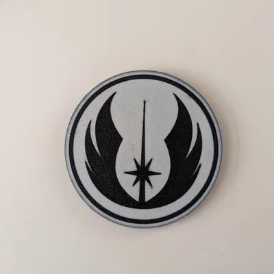 Đế lót ly đa màu sắc với logo Jedi Order trong Star Wars