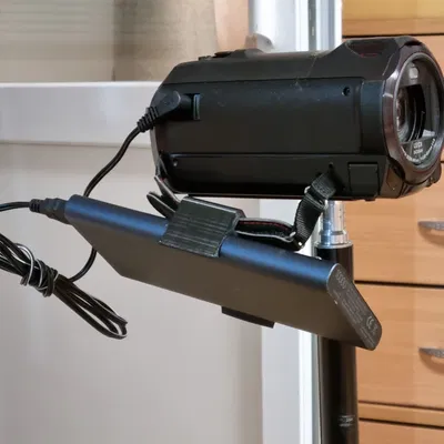 Giá đỡ pin ngoài cho máy quay cầm tay nhỏ