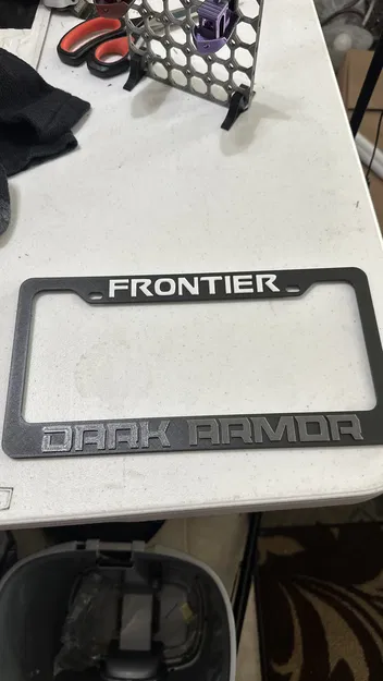 Ốp che biển số Nissan Frontier Dark Armor - Image 1