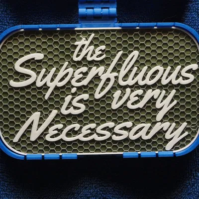 Bảng hiệu "The Superfluous is very Necessary"