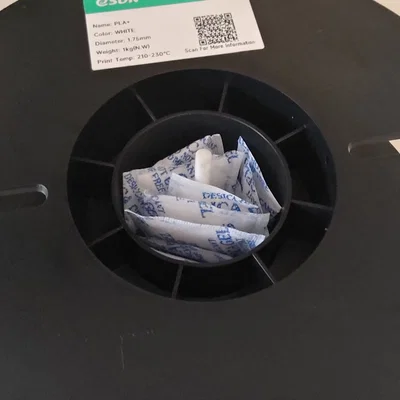 Bộ giá đỡ túi hút ẩm đặt trong cuộn nhựa (In-spool desiccant bag holder)