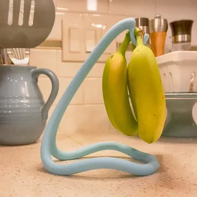 FlowFrame Banana Cradle - Kệ treo chuối nghệ thuật hiện đại