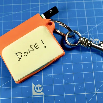 Móc khóa đa năng tích hợp giấy note và bút viết mini tiện lợi