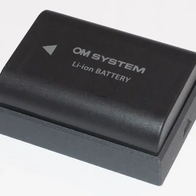 Nắp che pin cho Olympus / OM System BLX-1